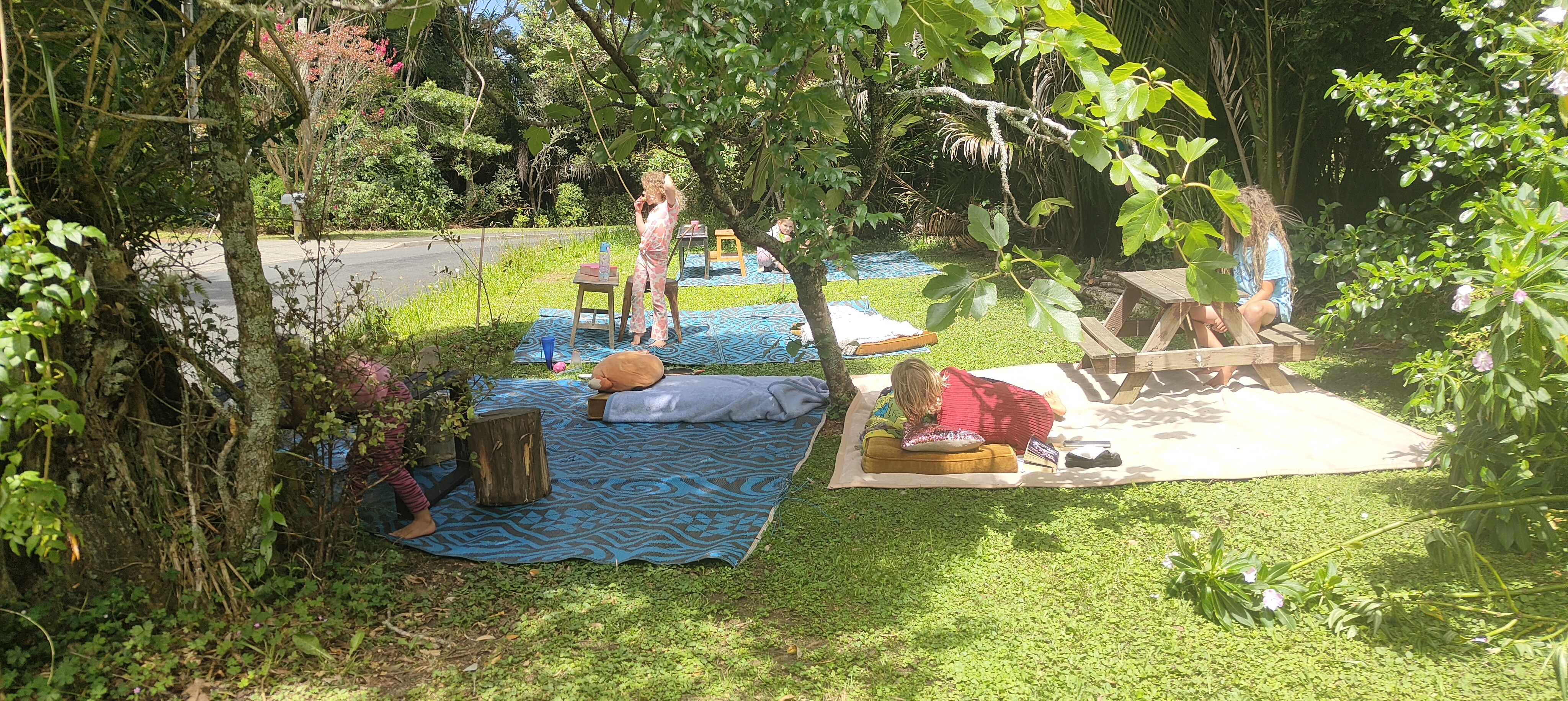 Relaxed outdoor learning space with mats and children